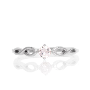 
            
                Load image into Gallery viewer, A product photo of an ornate silver ring with a morganite centre stone sitting on a white background. The silver band splits halfway along its length, becoming twisting and serpentine in appearance before meeting on either side of the dazzling pale pink 3.5mm stone, which is held in place by 4 silver claws.
            
        