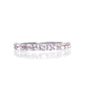 A product photo of a silver eternity band with 13 morganite stones embedded along its length on a white background.