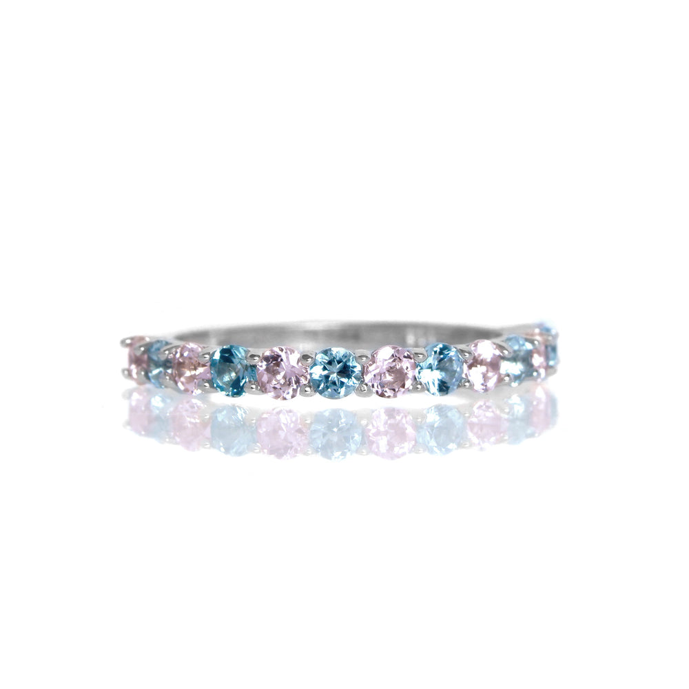 A product photo of a silver eternity band with 13 colour gemstones in alternating order embedded along its length on a white background.