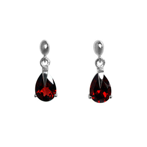 A product photo of a pair of 9x7mm pear-shaped red garnet drop earrings in 925 sterling silver on a white background. The gemstones are a deep, crimson hue, and are each held in place with a singular sharp prong, giving them a severe yet elegant appearance.