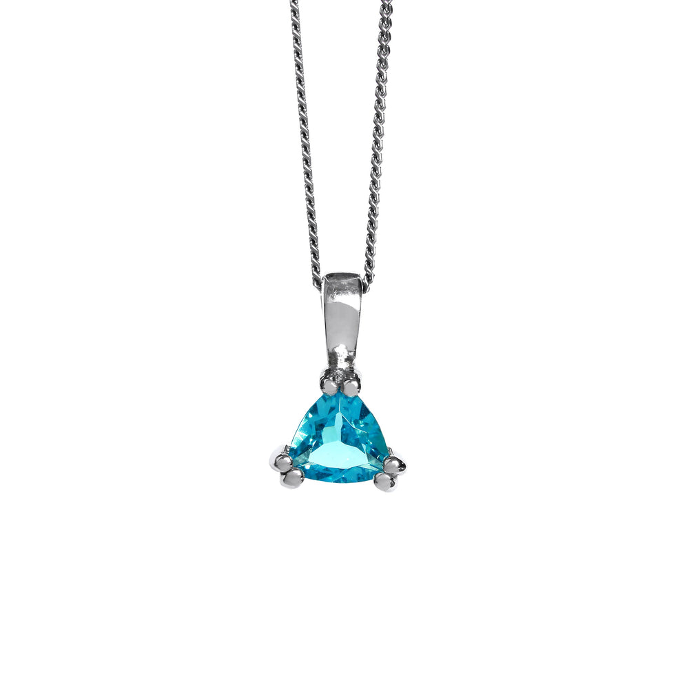 A product photo of a 6mm Trilliant blue topaz Pendant in silver suspended against a white background. The stone is held in place by 6 delicate silver claws, 2 on each corner. It is suspended by a simple silver chain.