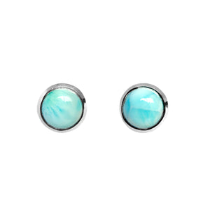 A product photo of a pair of silver Larimar gemstone stud earrings sitting against a white background. The 10mm round gemstones have dappled white and light blue patterning, similar to water reflections at the bottom of a pool, and are secured in place in bezel settings.