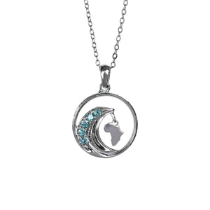 A product photo of an African-inspired silver pendant suspended by a silver chain against a white background. The pendant is composed of a circular frame with a silver "wave" contained within it. Along the curve of the wave are 5 embedded aquamarine stones. Dangling from the tip of the wave is a delicate cut-out of the African continent.