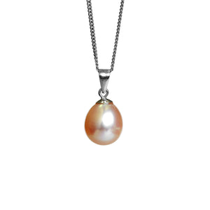 A product photo of a pearl pendant hanging by a white gold chain over a white background. The featured stone is a 11x9mm Peach Pearl with a soft orange sheen.