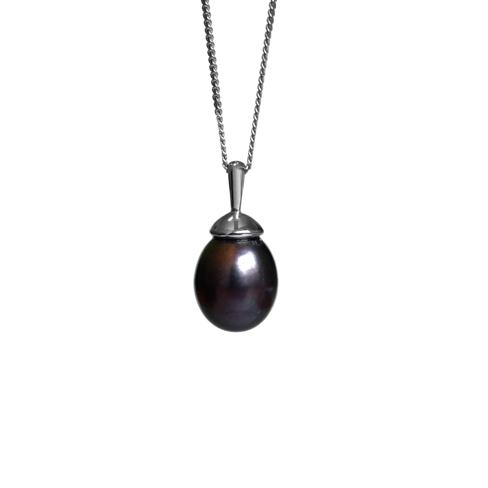 A product photo of a pearl pendant hanging by a white gold chain over a white background. The featured stone is an 11x9mm Peacock Pearl with a soft purple sheen.