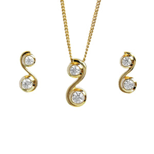 A product photo of a women's jewellery gift set in 9ct yellow gold and sparkling moissanite suspended against a white background. The yellow gold moissanite earrrings, each shaped like an "S" letter with a single sparkling moissanite nestled in each curve, sit on either side of a pendant of the same design suspended by a golden chain.