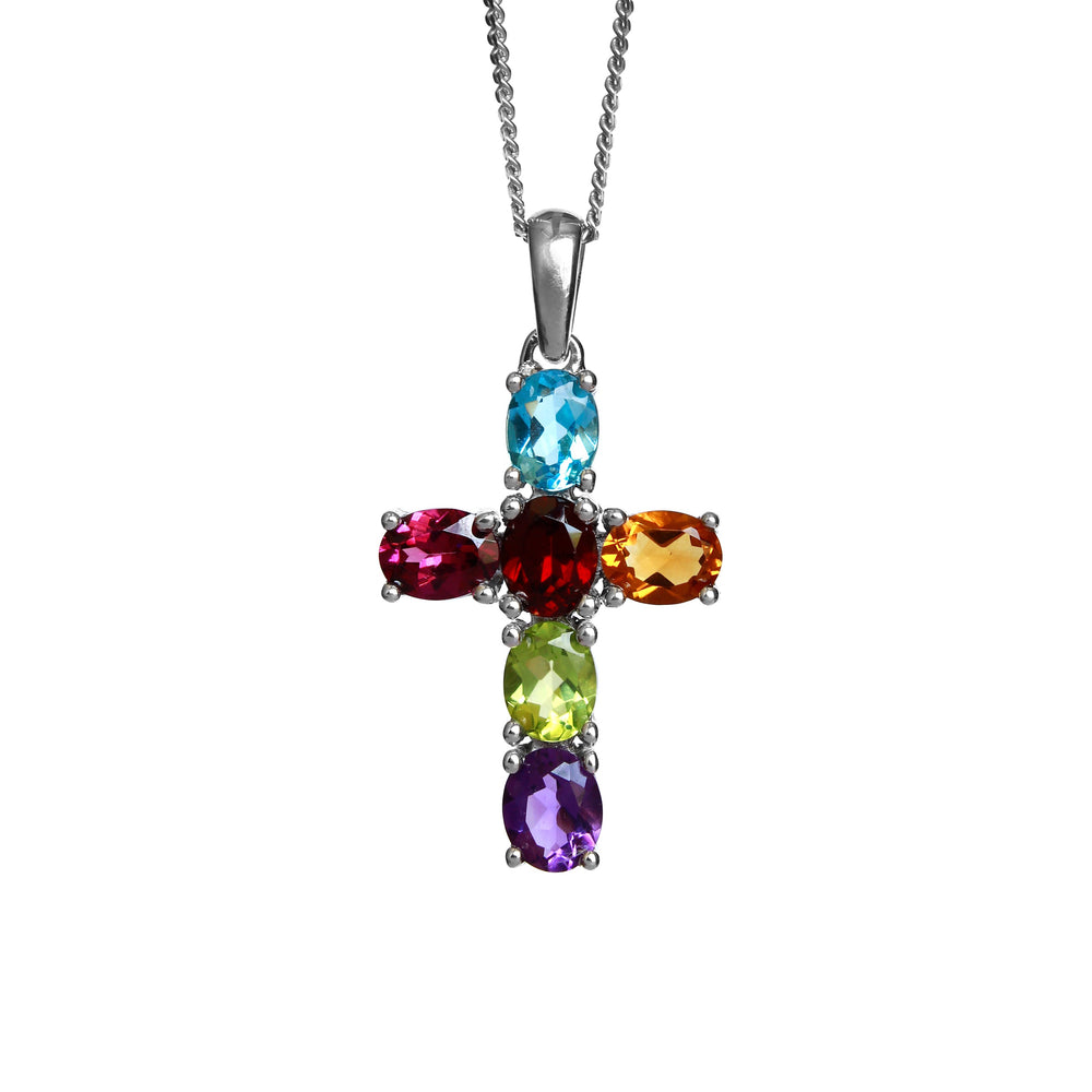 A product photo of a white gold cross pendant delicately bejewelled with multi-coloured gemstones suspended by a chain against a white background. The Christian cross pendant is made up of 6 oval stones in total.