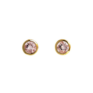 A product photo of yellow gold morganite stud earrings sitting on a white background. The bezel settings of the stones are slim, drawing the viewers focus to the stones themselves. The pale pink morganite stones reflect bright white light from their many edges.